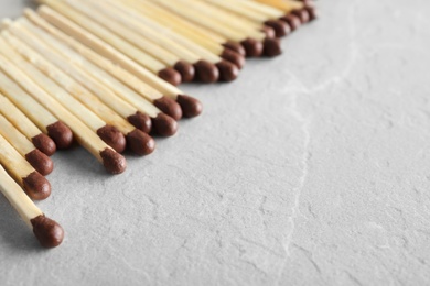 Photo of Many matches on light background, space for text