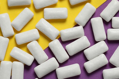 Photo of Tasty white chewing gums on color background, flat lay