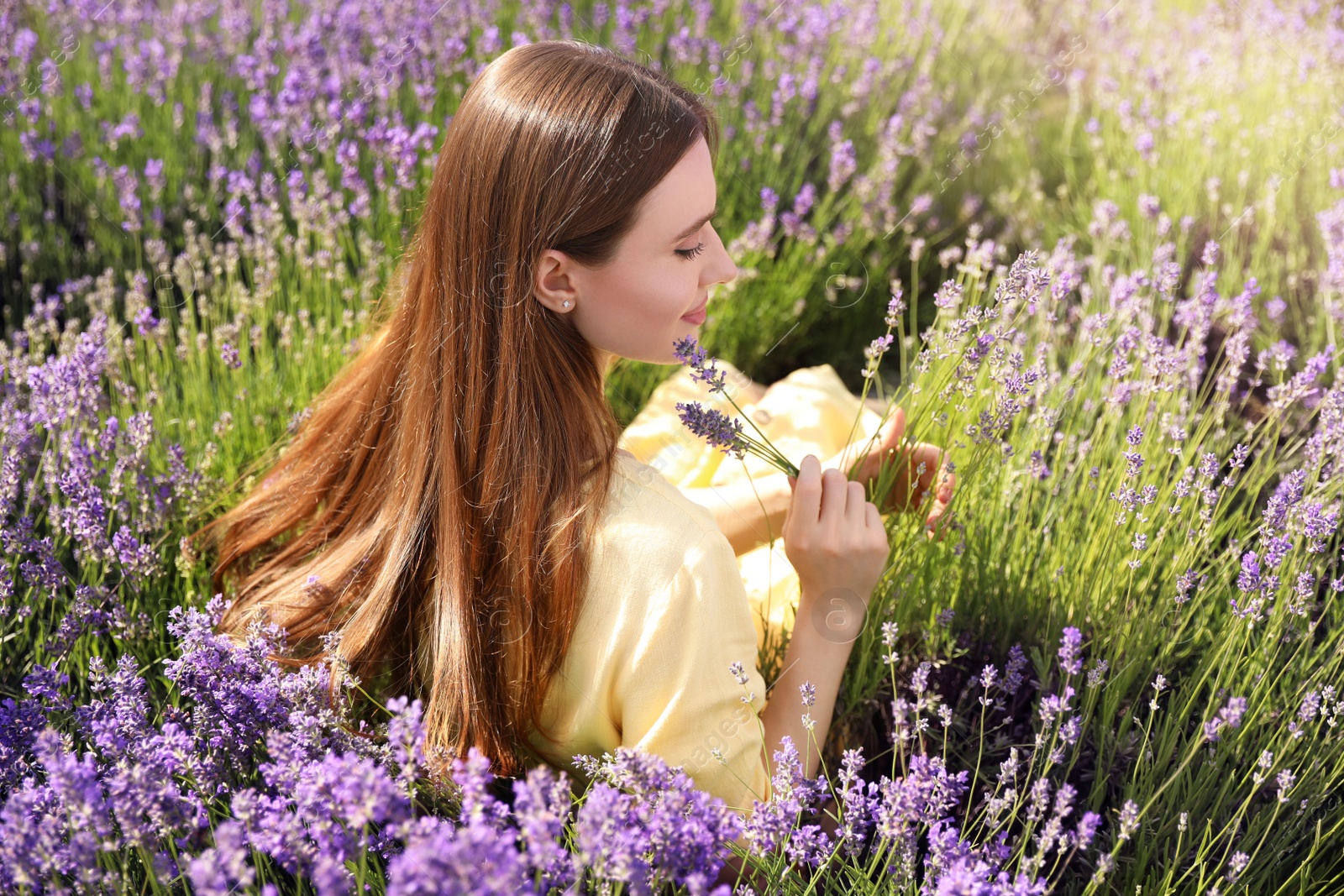 Photo of Young woman in lavender field on summer day