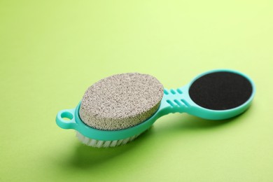 Photo of Pedicure tool with pumice stone, brush and foot file on green background