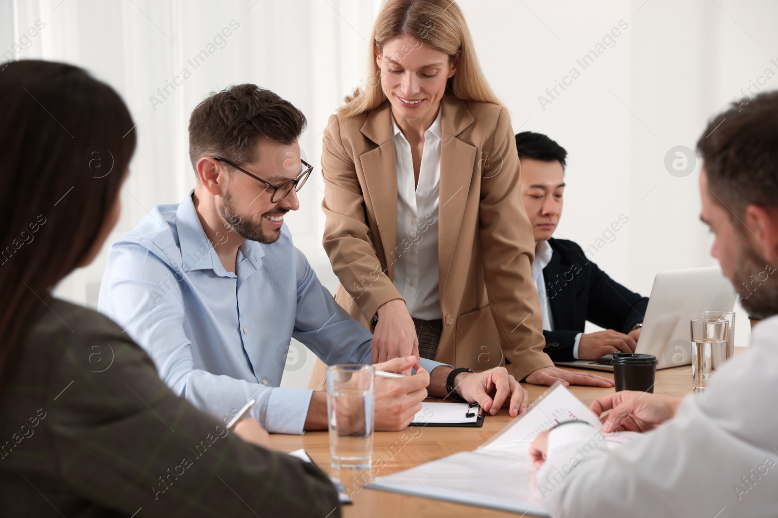 Photo of Businesswoman having meeting with her employees in office