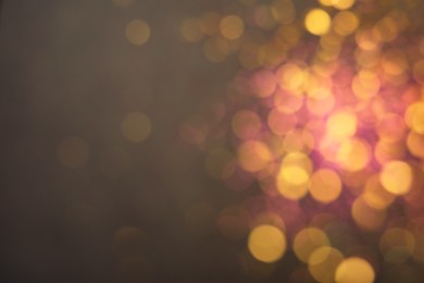Photo of Blurred view of shiny lights on grey background. Bokeh effect
