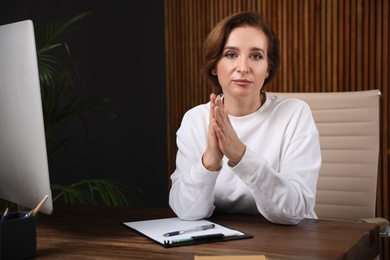 Portrait of psychotherapist at table in office