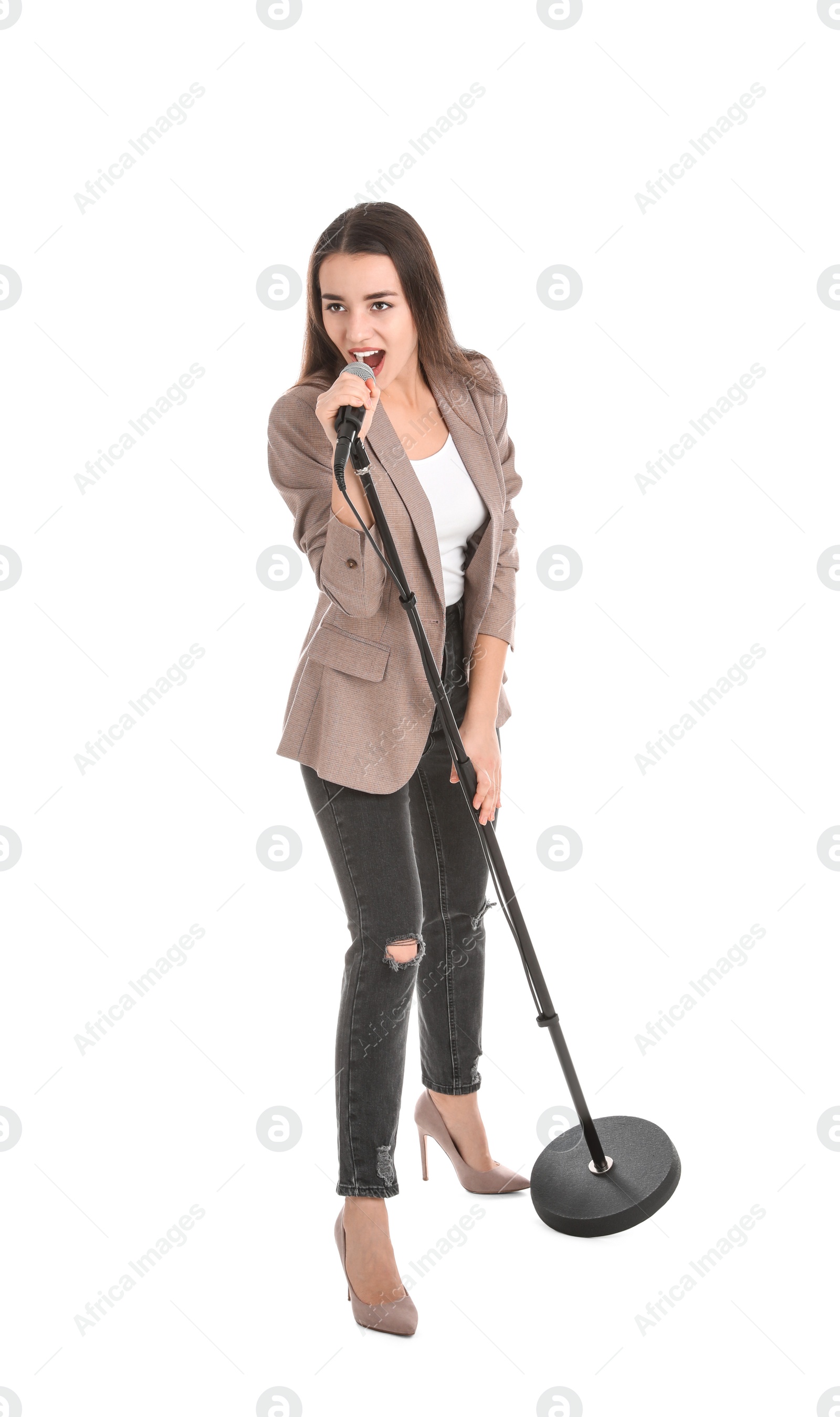 Photo of Young stylish woman singing in microphone on white background