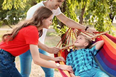 Happy couple with son spending time together outdoors