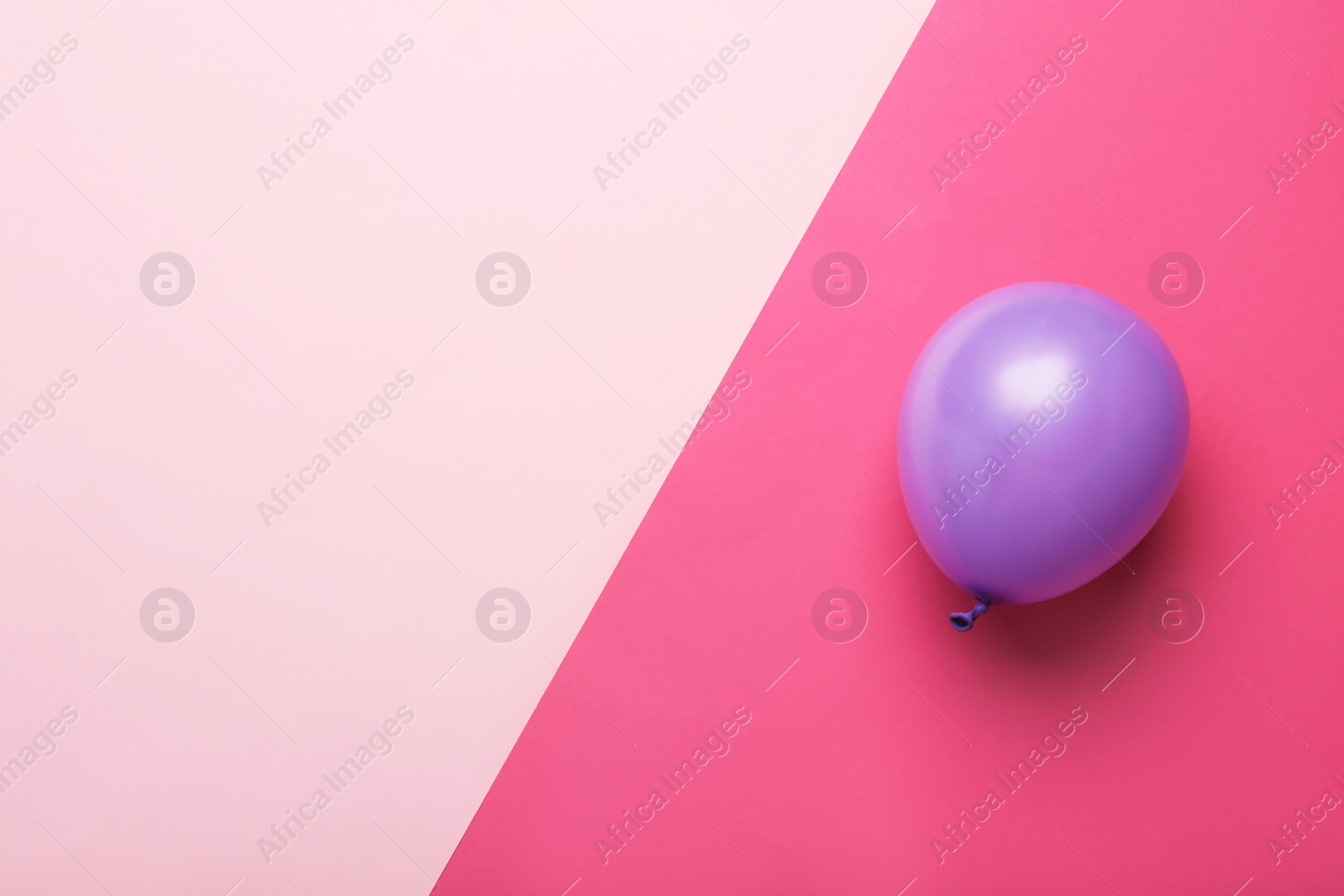 Photo of Colorful balloon and space for text on color background, top view