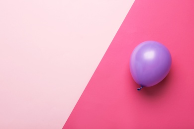 Photo of Colorful balloon and space for text on color background, top view