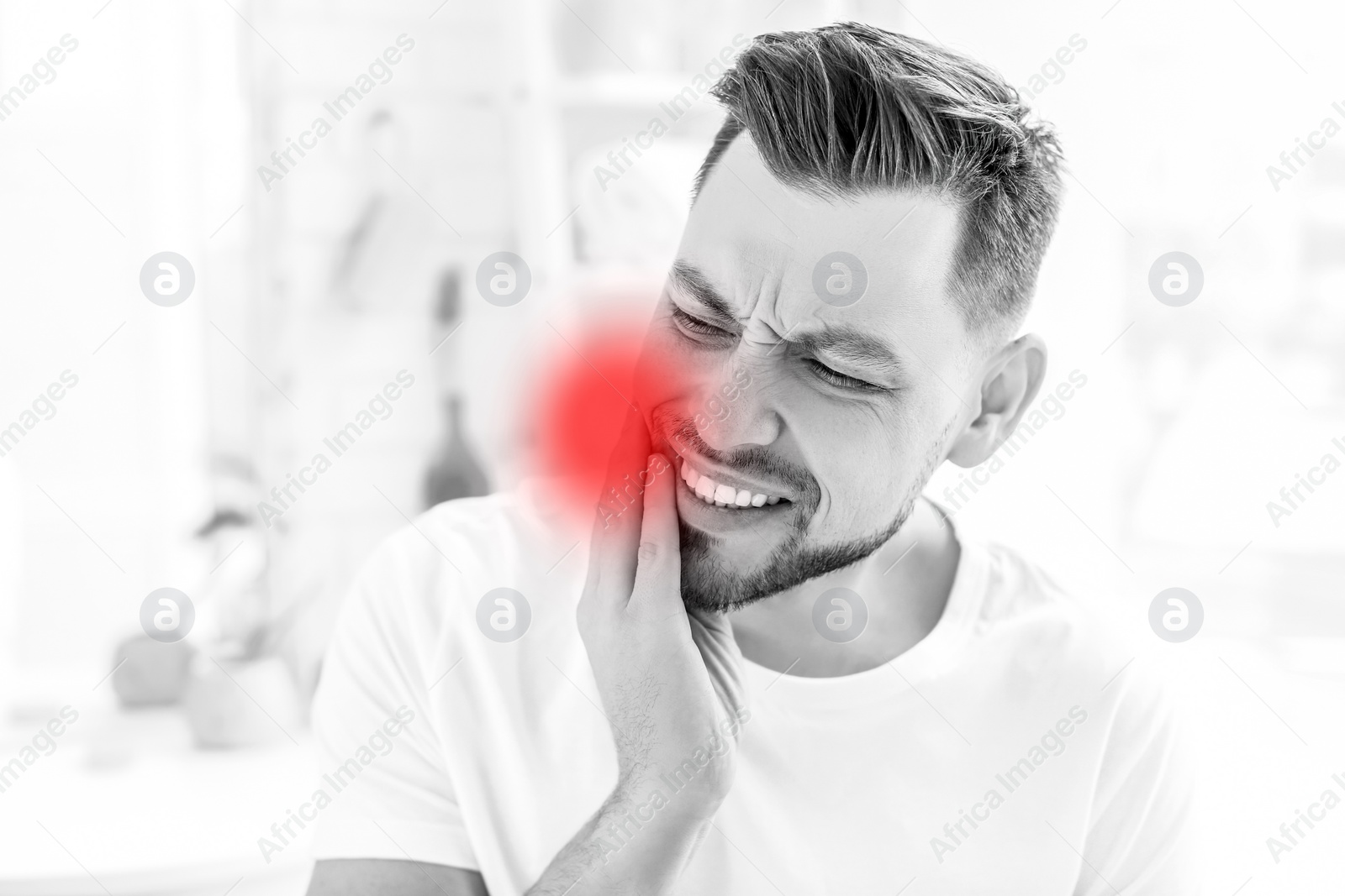 Image of Man suffering from strong toothache at home