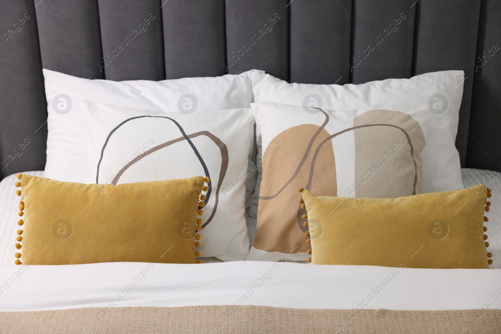 Photo of Soft pillows and warm duvet on bed