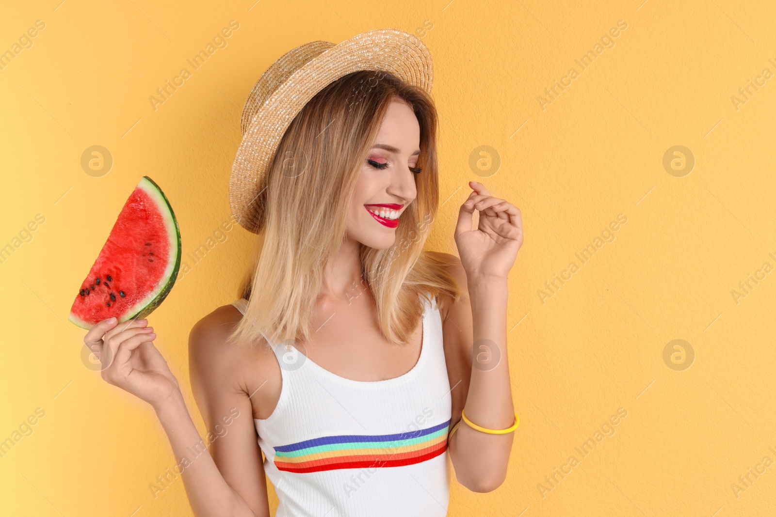 Photo of Pretty young woman with juicy watermelon on color background