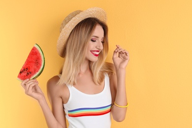 Pretty young woman with juicy watermelon on color background