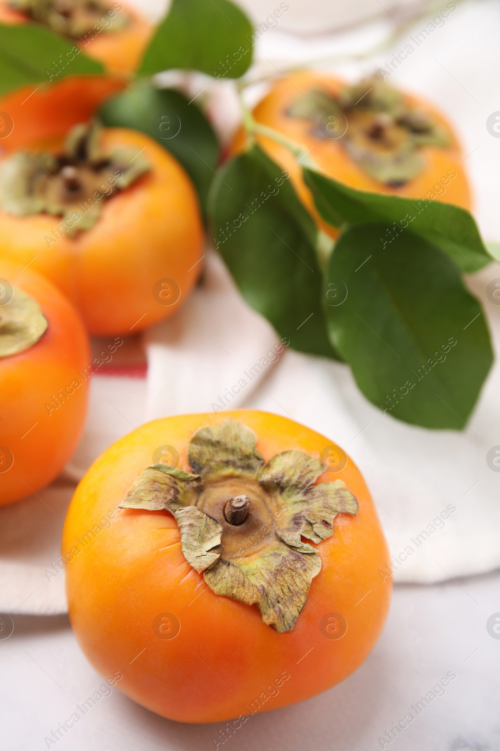 Photo of Delicious ripe juicy persimmons on table, closeup