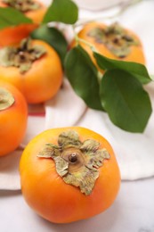 Delicious ripe juicy persimmons on table, closeup