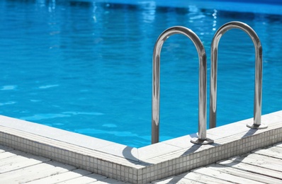 Photo of Modern swimming pool with step ladder outdoors