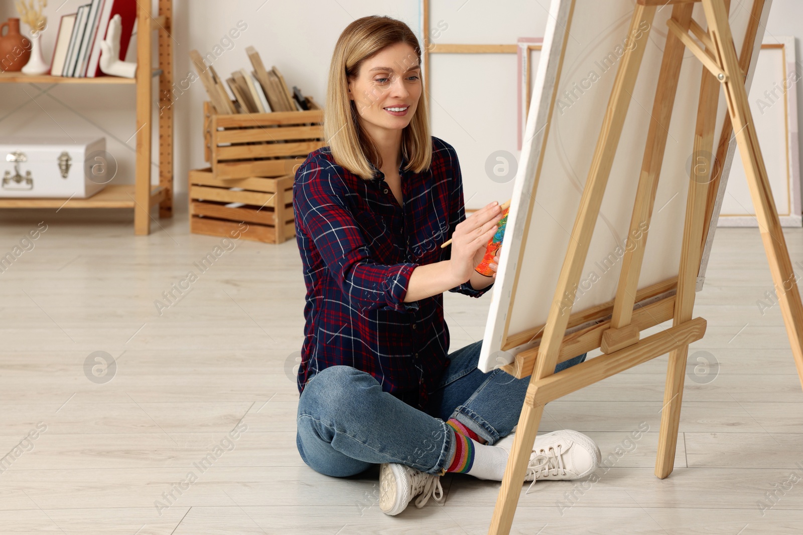 Photo of Beautiful woman painting in studio. Creative hobby