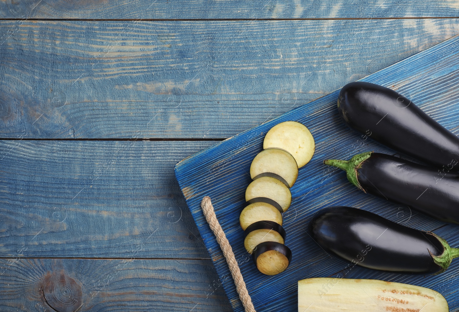 Photo of Flat lay composition with ripe eggplants on wooden background