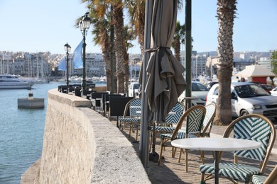 Beautiful view of modern cafe with outdoor terrace near port