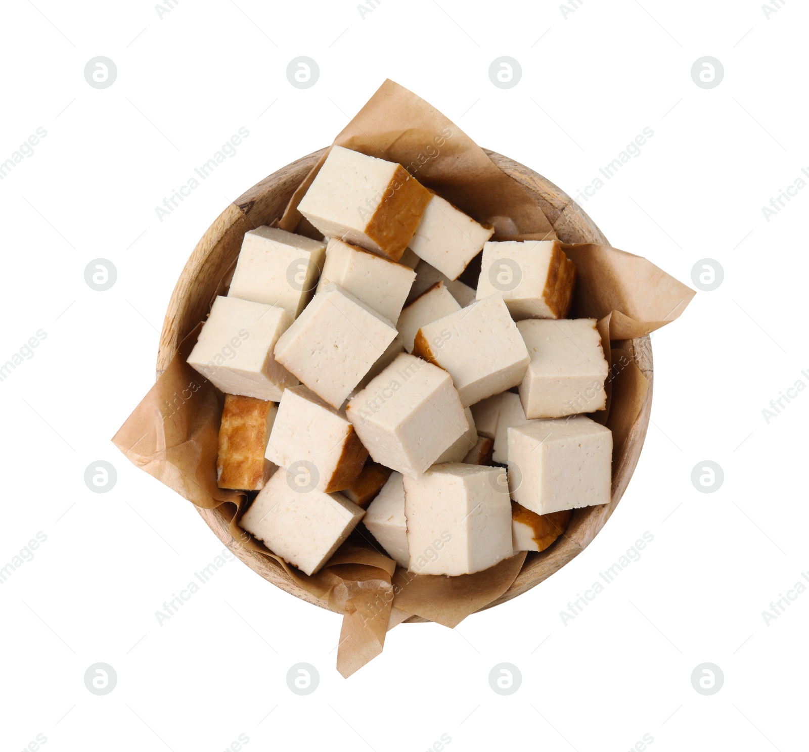 Photo of Bowl of delicious smoked tofu cubes isolated on white, top view