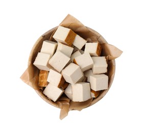 Photo of Bowl of delicious smoked tofu cubes isolated on white, top view