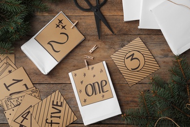 Flat lay composition with gift bags on wooden table. Creating advent calendar