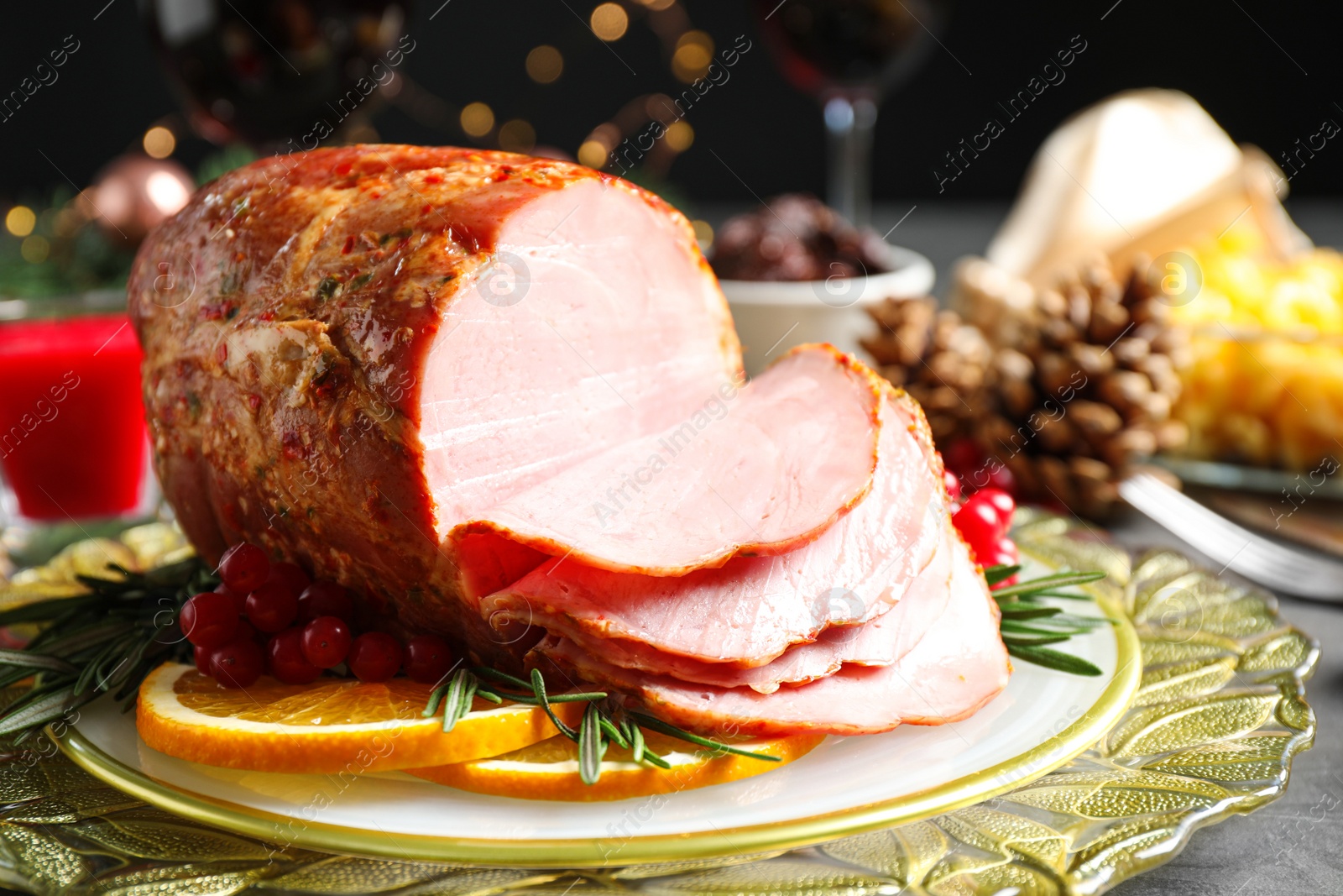 Photo of Plate with delicious ham served on grey table. Christmas dinner