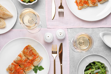 Photo of Delicious cabbage rolls served on grey table, flat lay