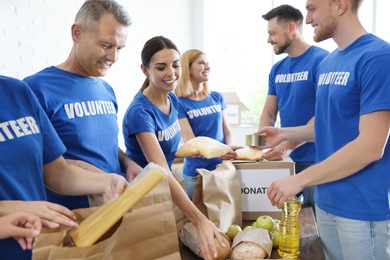 Photo of Team of volunteers collecting food donations indoors