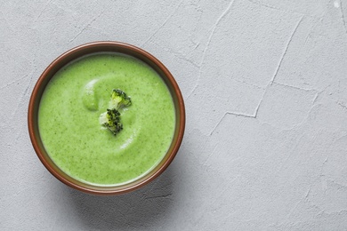 Photo of Fresh vegetable detox soup made of broccoli in dish on table, top view with space for text