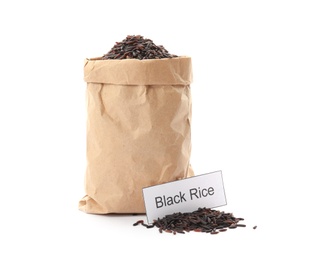 Paper bag with uncooked black rice and card on white background