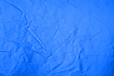 Photo of Sheet of crumpled blue paper as background, top view