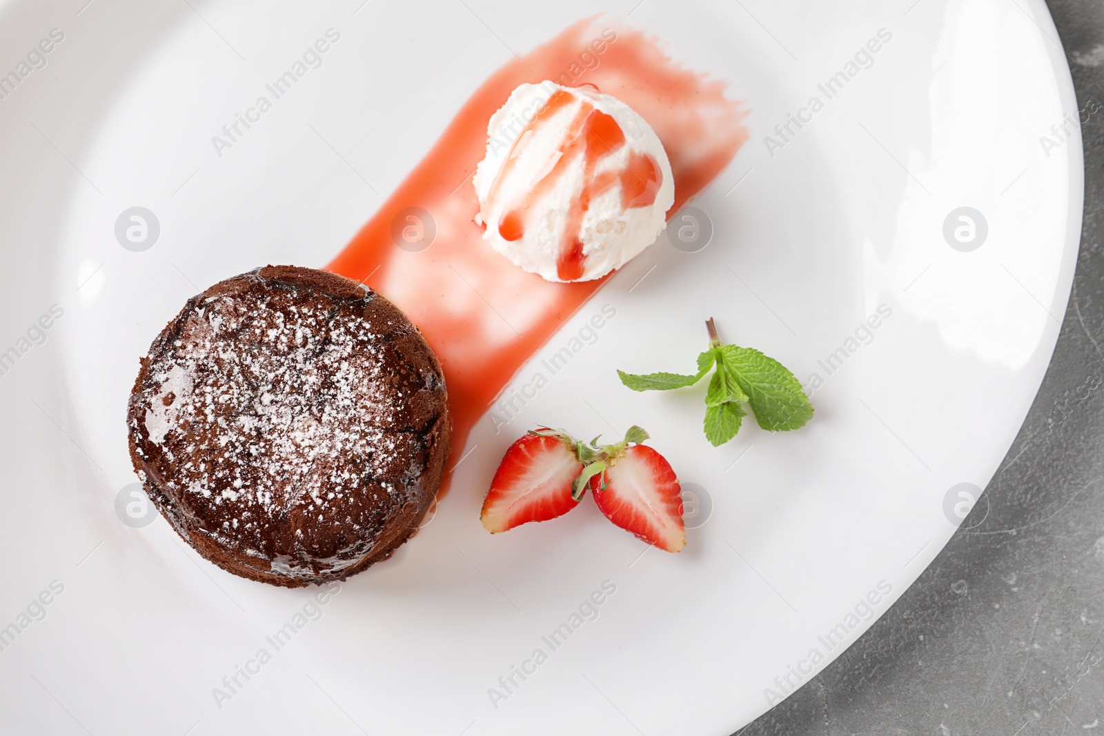 Photo of Delicious fresh fondant with hot chocolate, ice cream and strawberry served on plate, top view. Lava cake recipe