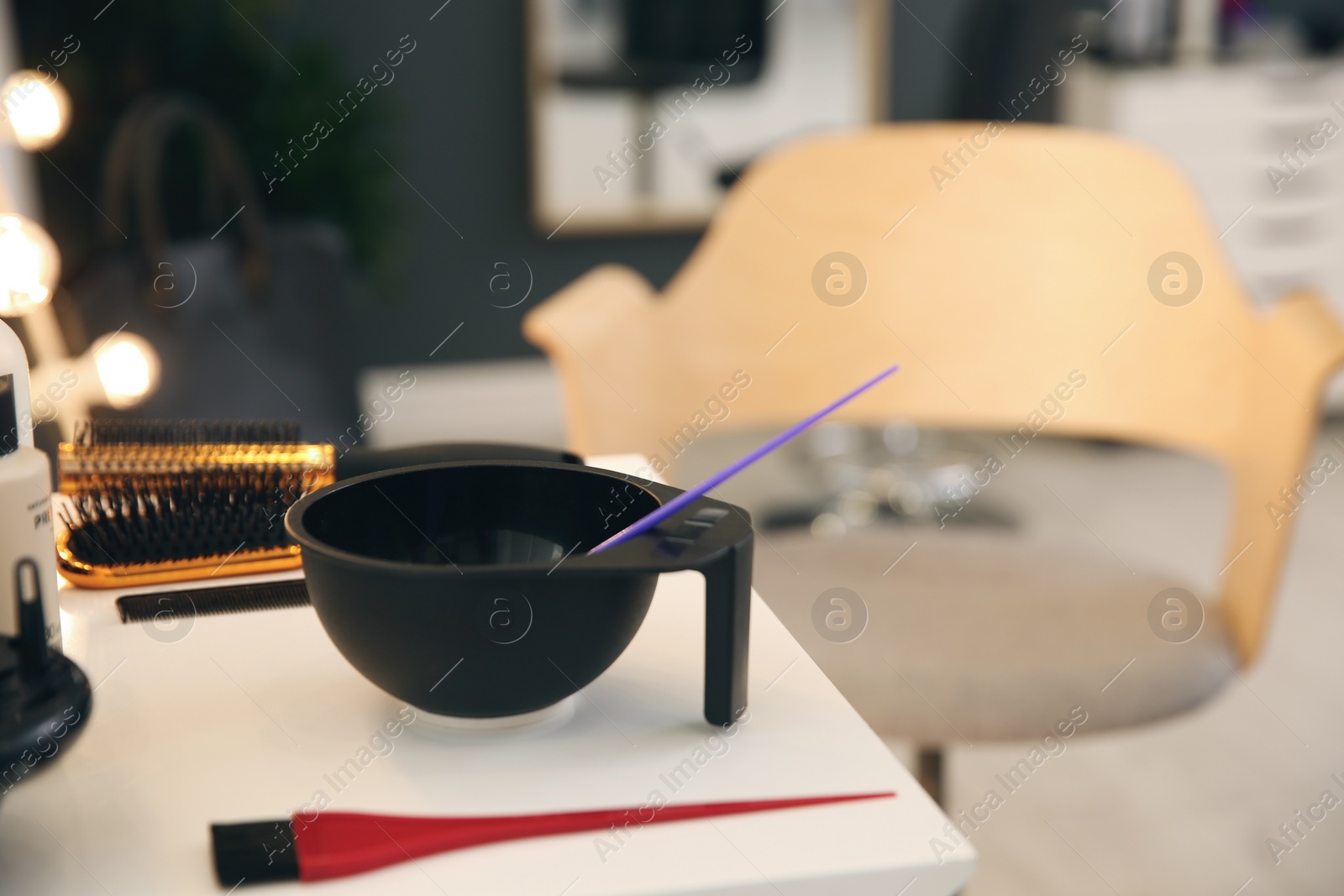 Photo of Workplace with hair dye kit on table in beauty salon