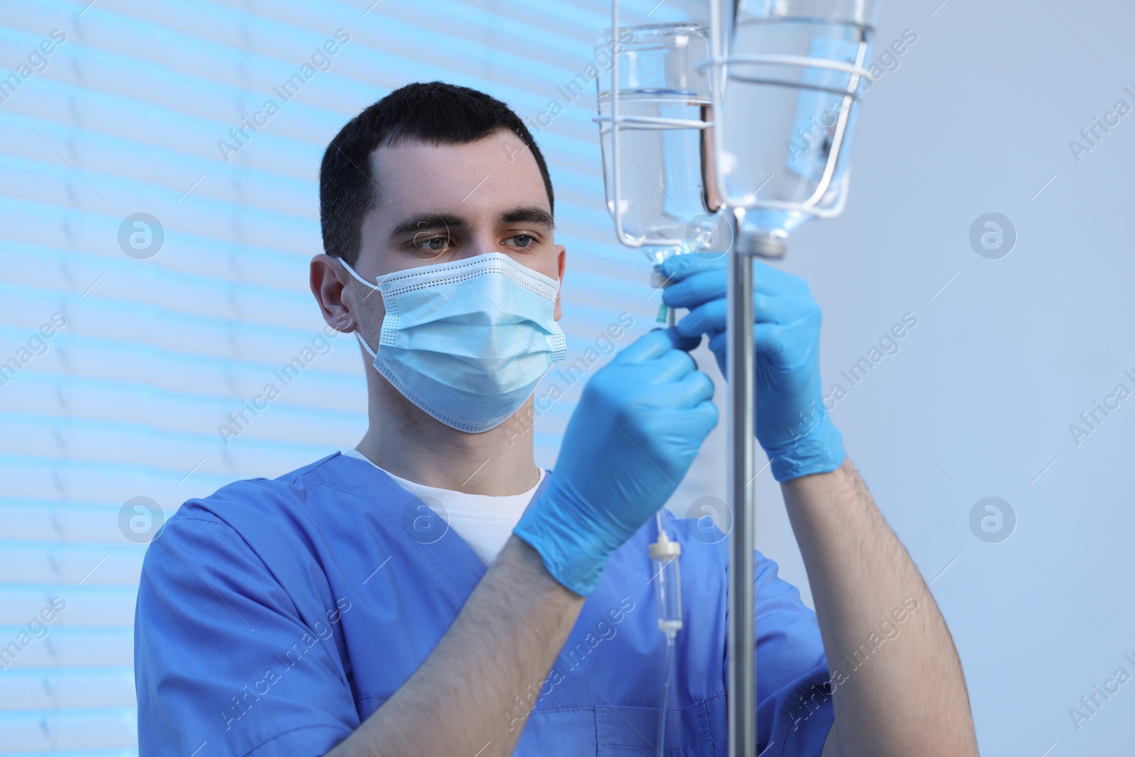 Photo of Nurse setting up IV drip in hospital