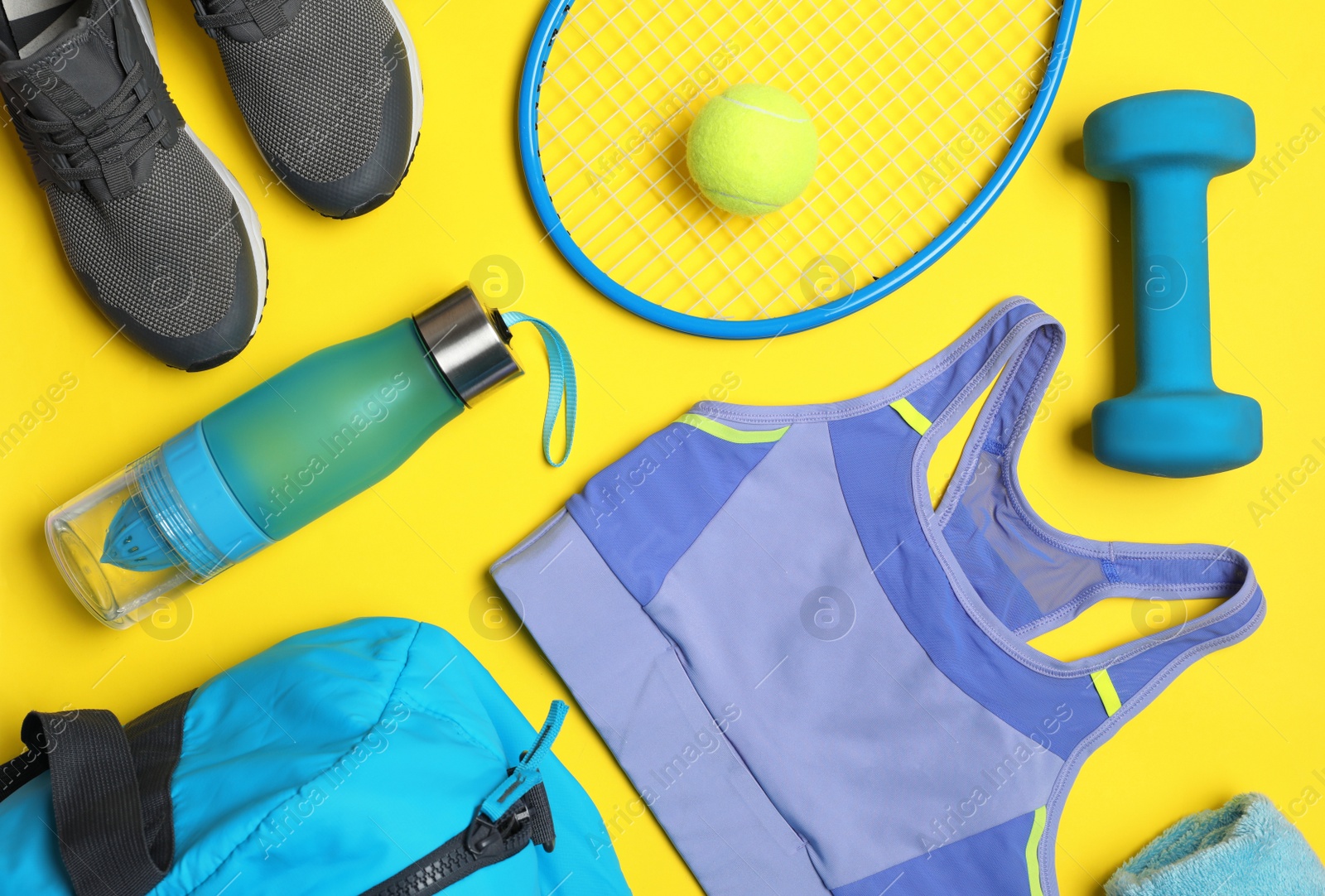 Photo of Flat lay composition with sports equipment on yellow background