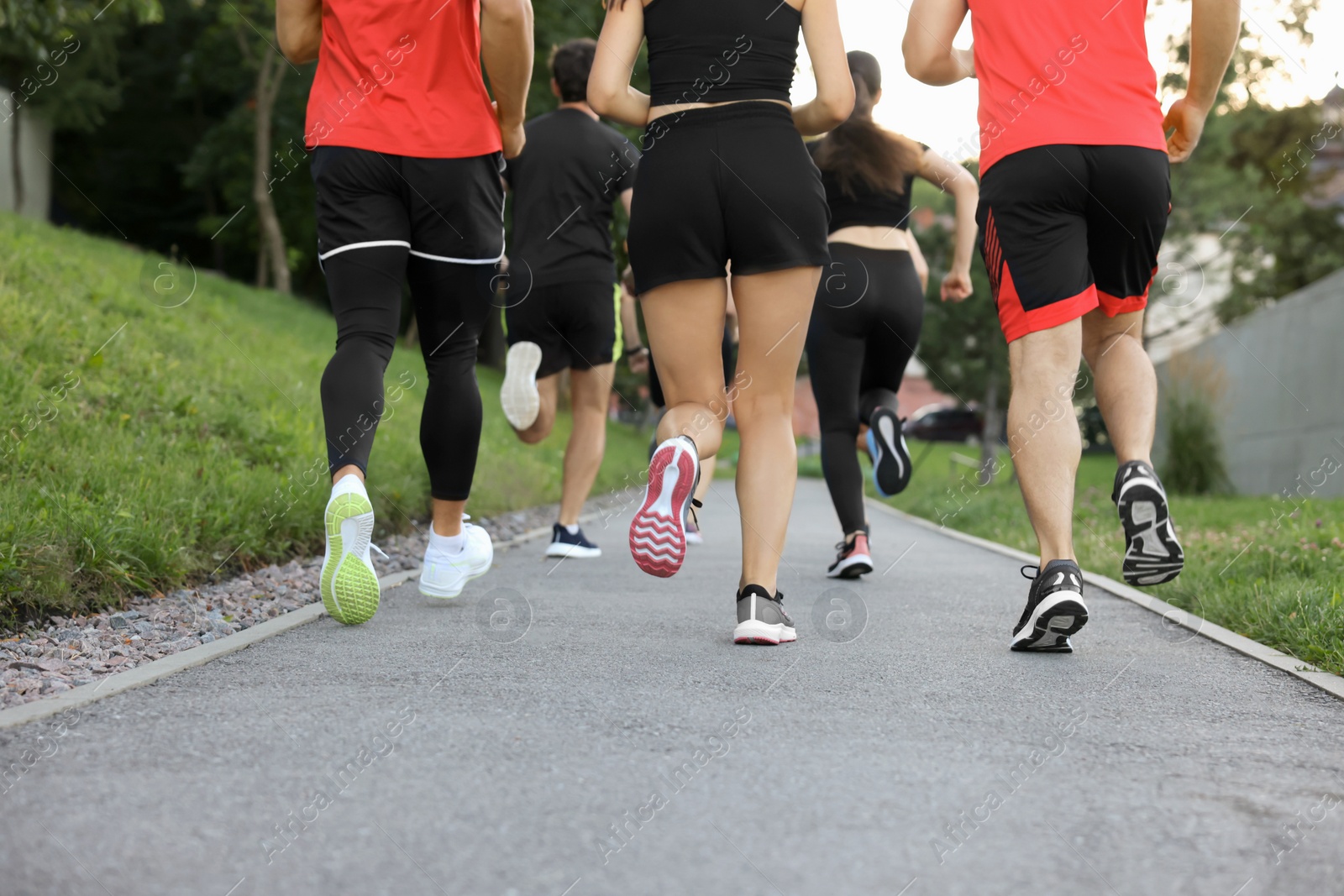 Photo of Group of people running outdoors, closeup view