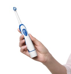 Photo of Woman holding electric toothbrush on white background, closeup