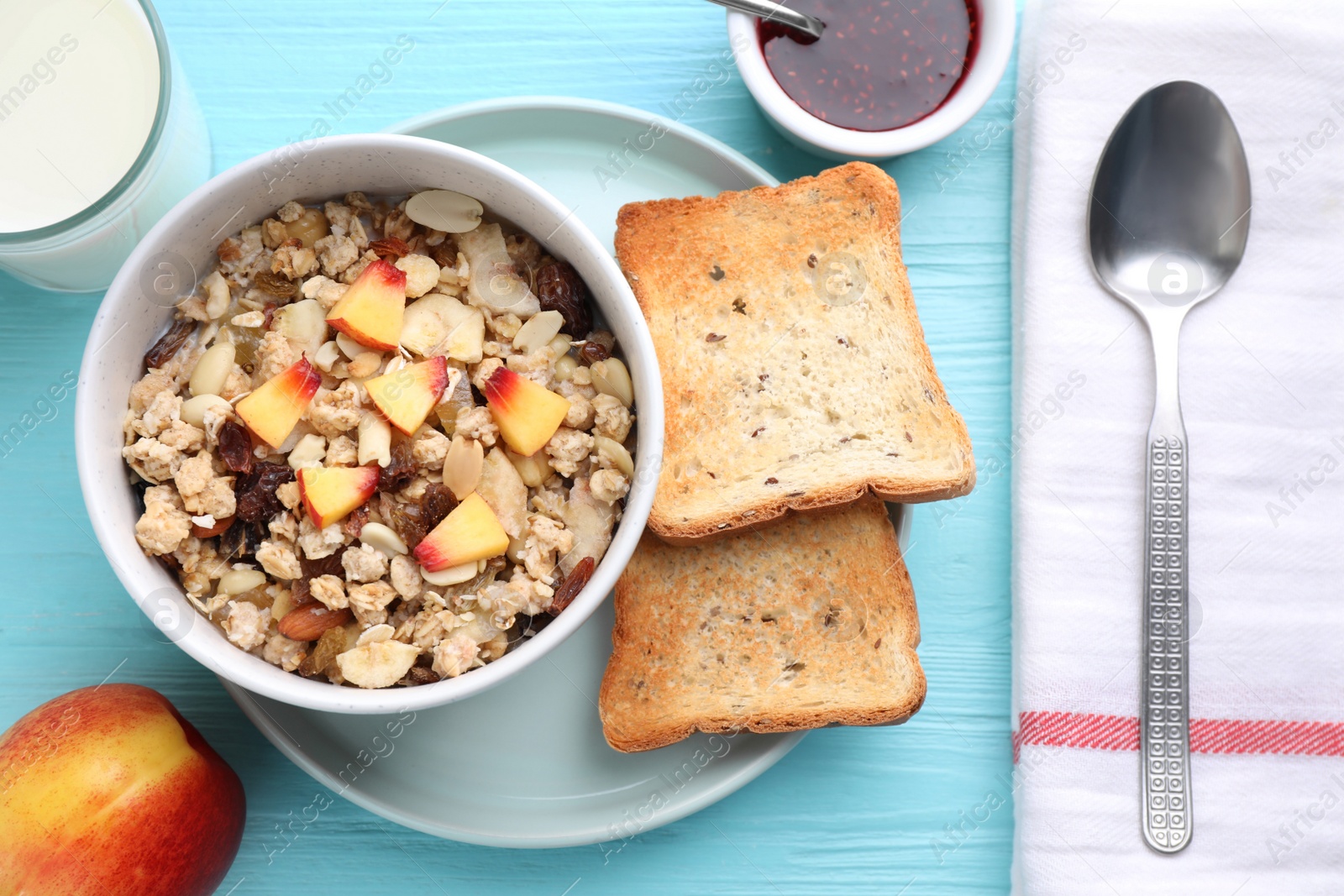 Photo of Flat lay composition with muesli and toasts on light blue wooden table. Healthy breakfast