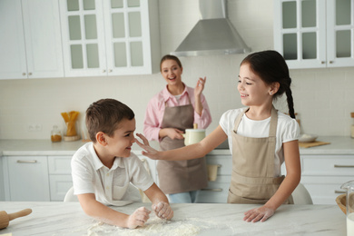 Happy family cooking together in kitchen at home