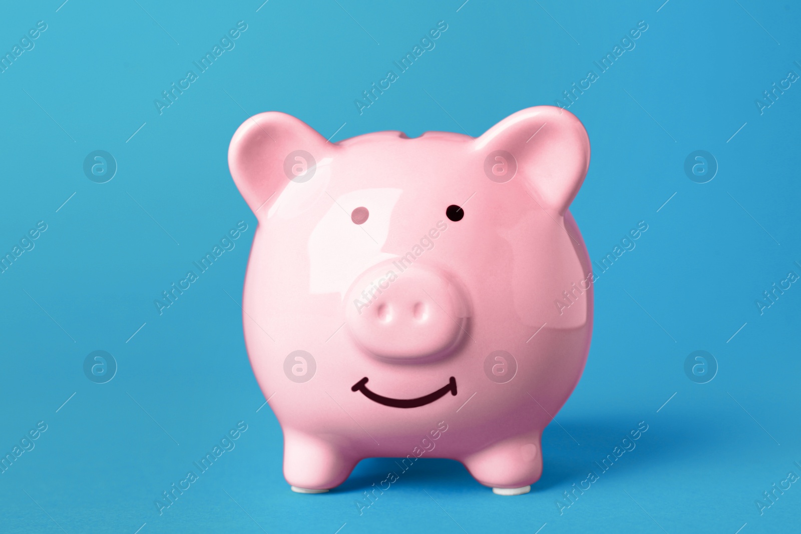 Photo of Ceramic piggy bank on turquoise background. Financial savings