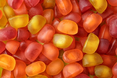 Sweet color jelly candies as background, top view