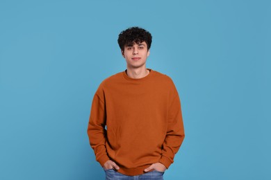 Photo of Portrait of handsome young man on light blue background