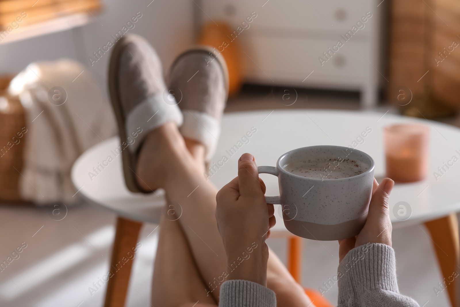 Photo of Woman with cup of aromatic coffee relaxing at home, closeup