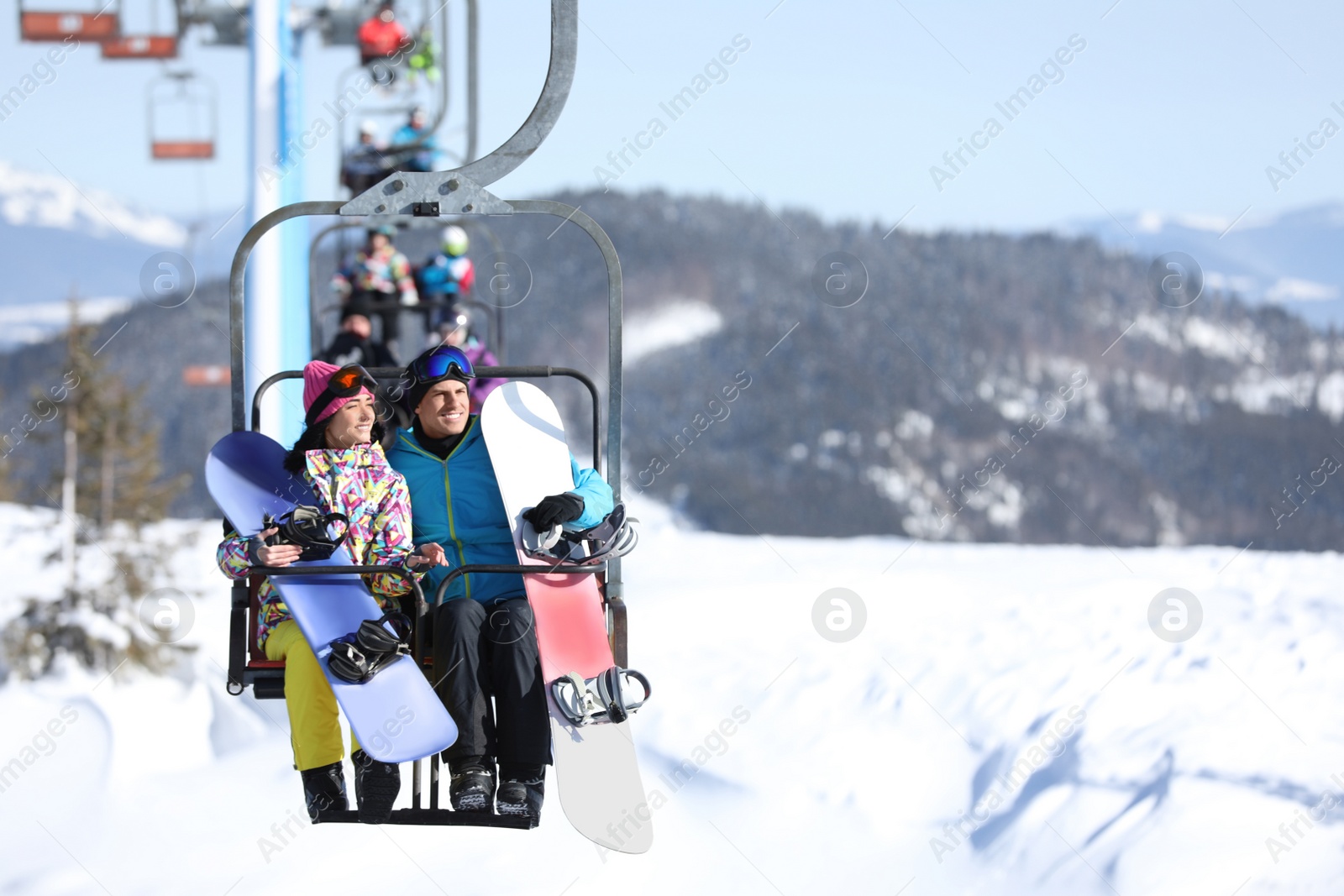 Photo of People using chairlift at mountain ski resort, space for text. Winter vacation