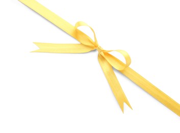 Yellow satin ribbon with bow on white background, top view