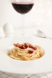 Photo of Delicious Carbonara pasta in plate on table