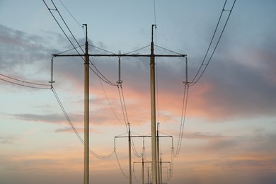 Photo of Telephone poles with cables under clear blue sky