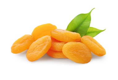 Photo of Pile of tasty dried apricots with leaves on white background