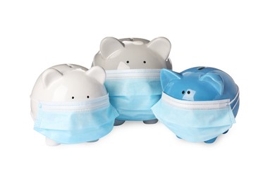 Photo of Piggy banks in protective masks on white background. Medical insurance