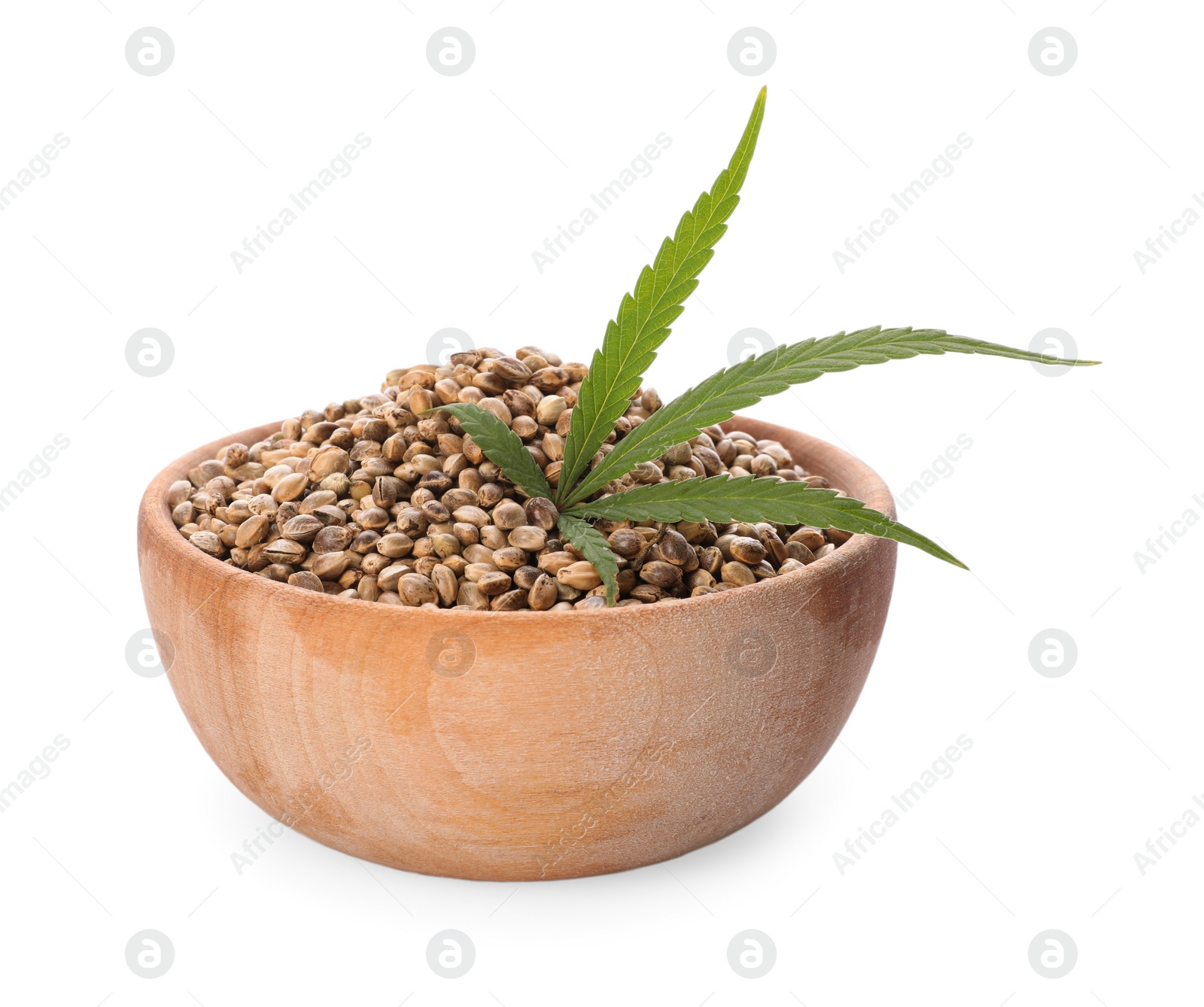 Photo of Wooden bowl of hemp seeds and leaf on white background