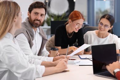 Team of employees working together in office